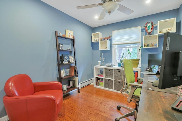 home office featuring wood finished floors, a ceiling fan, a baseboard heating unit, and recessed lighting