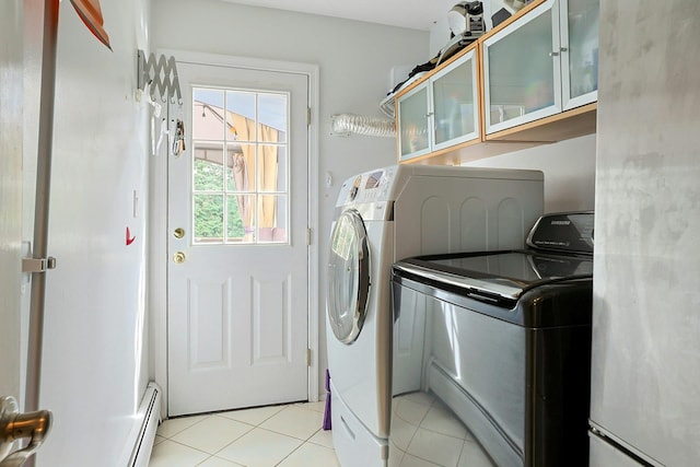 laundry room featuring light tile patterned floors, separate washer and dryer, laundry area, and a baseboard radiator