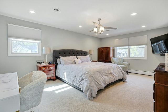 carpeted bedroom with visible vents, a baseboard heating unit, ceiling fan, and recessed lighting