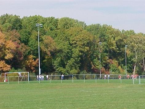 surrounding community featuring a wooded view
