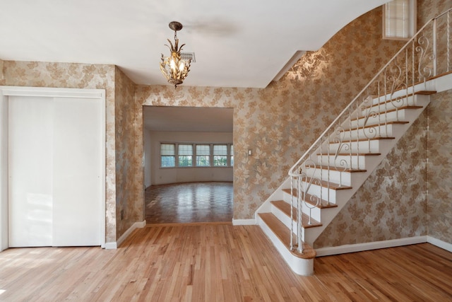4 Penn Ct, Dix Hills, NY 11746 - staircase featuring baseboards, hardwood / wood-style floors, and wallpapered walls