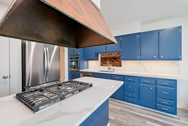 4 Penn Ct, Dix Hills, NY 11746 - kitchen featuring light wood-style flooring, a sink, stainless steel appliances, light stone counters, and blue cabinetry
