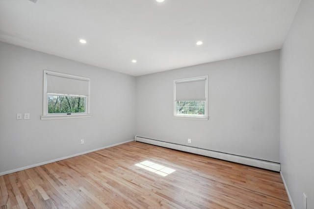 4 Penn Ct, Dix Hills, NY 11746 - spare room with a baseboard radiator, recessed lighting, plenty of natural light, and wood finished floors