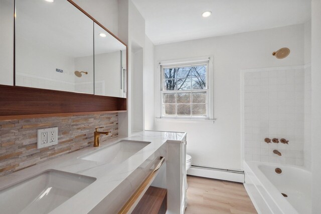 4 Penn Ct, Dix Hills, NY 11746 - full bathroom with toilet, wood finished floors, a baseboard heating unit, backsplash, and vanity