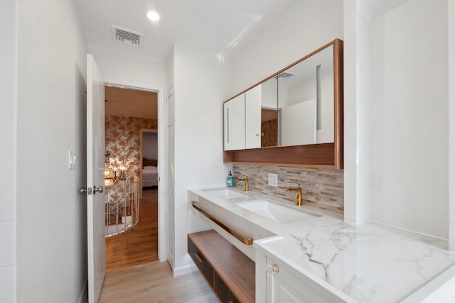 4 Penn Ct, Dix Hills, NY 11746 - bathroom featuring a sink, backsplash, visible vents, and wood finished floors