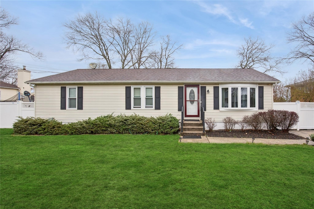 5 Bonny Dr, Mastic, NY 11950 - view of front of house featuring entry steps, roof with shingles, fence, and a front lawn
