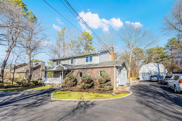 1170 Carlls Straight Path, Dix Hills, NY 11746 - view of front of property featuring a chimney, covered porch, an outdoor structure, and brick siding