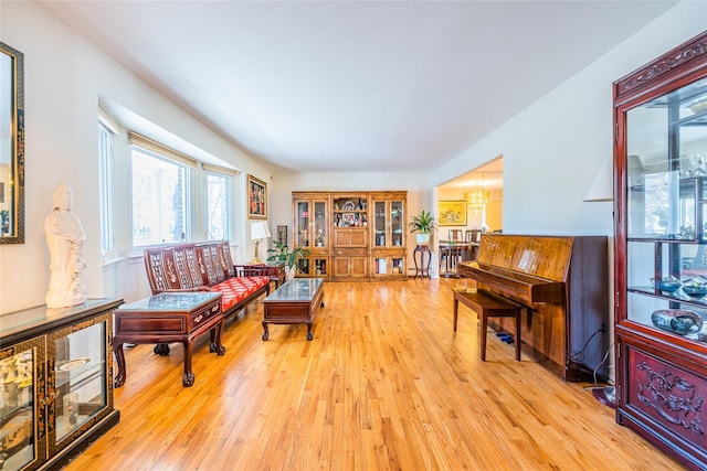 1170 Carlls Straight Path, Dix Hills, NY 11746 - living room with light wood-style flooring and a chandelier