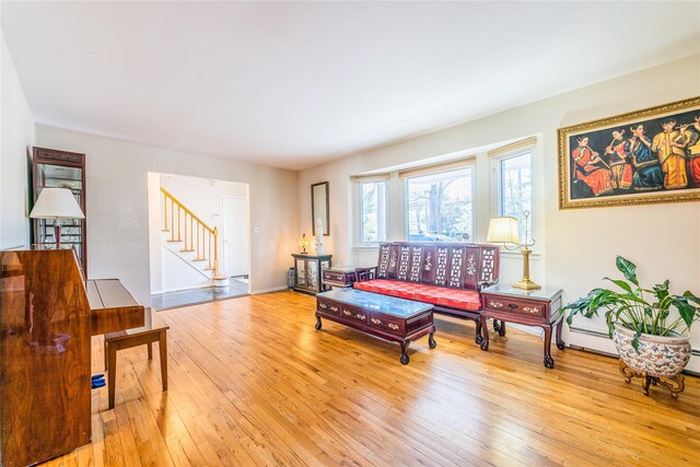 1170 Carlls Straight Path, Dix Hills, NY 11746 - living area with baseboards, stairs, and light wood-style floors