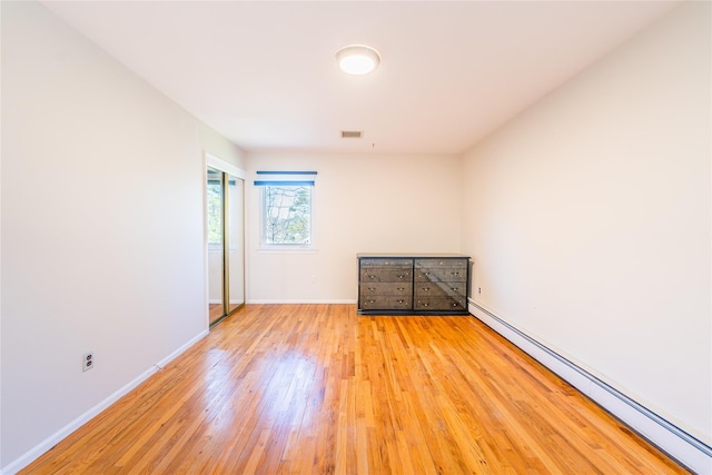 1170 Carlls Straight Path, Dix Hills, NY 11746 - spare room with baseboards, baseboard heating, visible vents, and light wood-style flooring