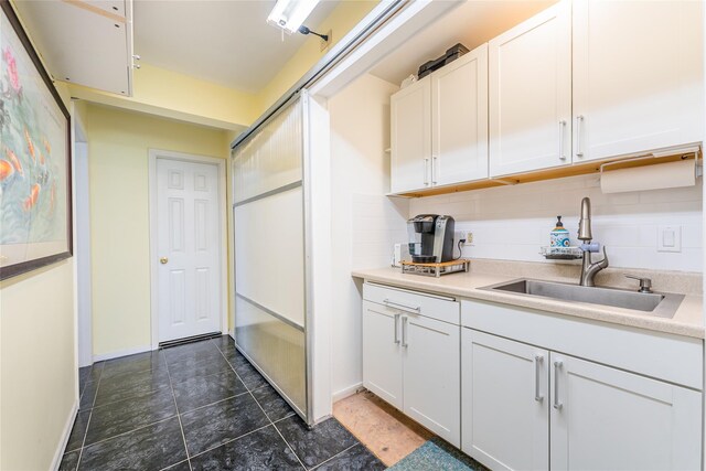 1170 Carlls Straight Path, Dix Hills, NY 11746 - kitchen featuring light countertops, baseboards, decorative backsplash, a sink, and white cabinets