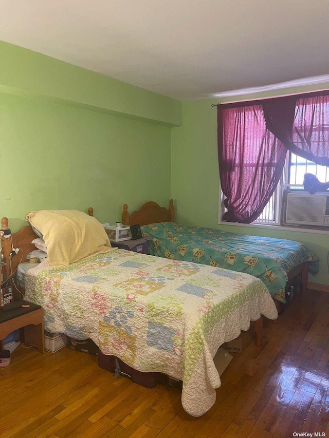 141-05 Northern Blvd Unit 6K, Flushing, NY 11355 - bedroom featuring cooling unit and wood-type flooring