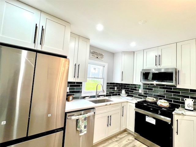 8-10 Mercer St, Middletown, NY 10940 - kitchen featuring appliances with stainless steel finishes, light countertops, white cabinets, and recessed lighting