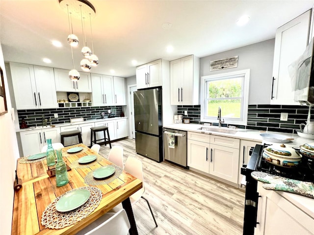 8-10 Mercer St, Middletown, NY 10940 - kitchen featuring appliances with stainless steel finishes, tasteful backsplash, light countertops, white cabinets, and recessed lighting