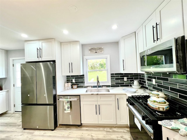8-10 Mercer St, Middletown, NY 10940 - kitchen featuring appliances with stainless steel finishes, decorative backsplash, light countertops, white cabinets, and recessed lighting