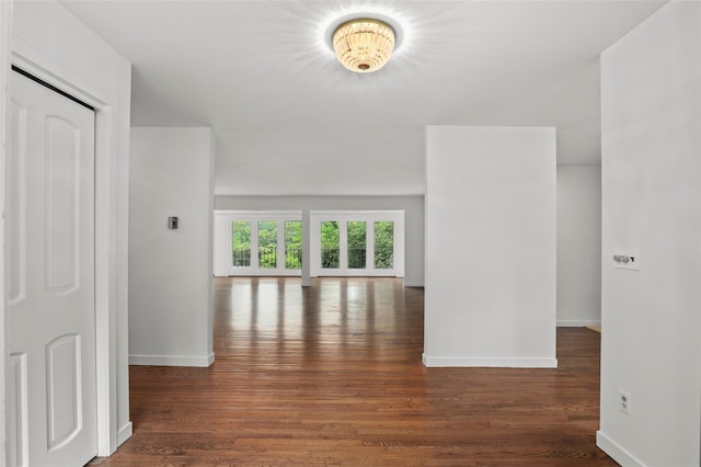 empty room featuring baseboards and wood finished floors
