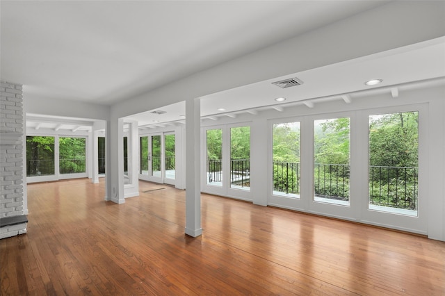 unfurnished living room with wood-type flooring
