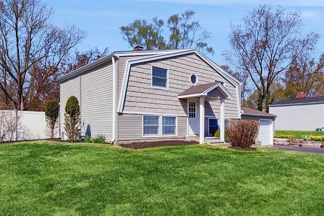 view of front of property with a garage, a chimney, a front lawn, and fence