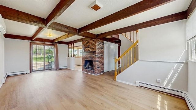unfurnished living room featuring beamed ceiling, wood finished floors, stairs, and baseboard heating