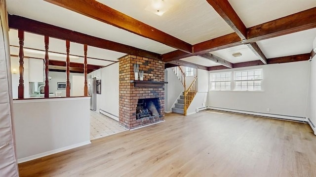 unfurnished living room with beamed ceiling, wood finished floors, stairs, and baseboards