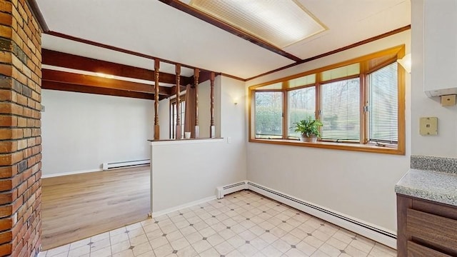 empty room with light floors, baseboards, and a baseboard radiator