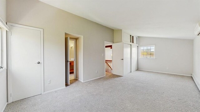unfurnished bedroom featuring carpet flooring, baseboards, and ensuite bathroom