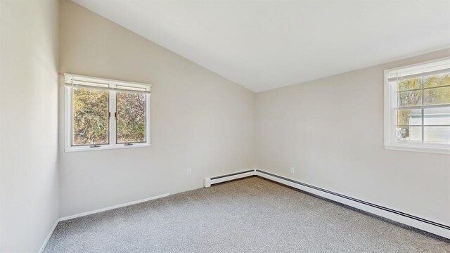 carpeted spare room featuring lofted ceiling, baseboard heating, and baseboards