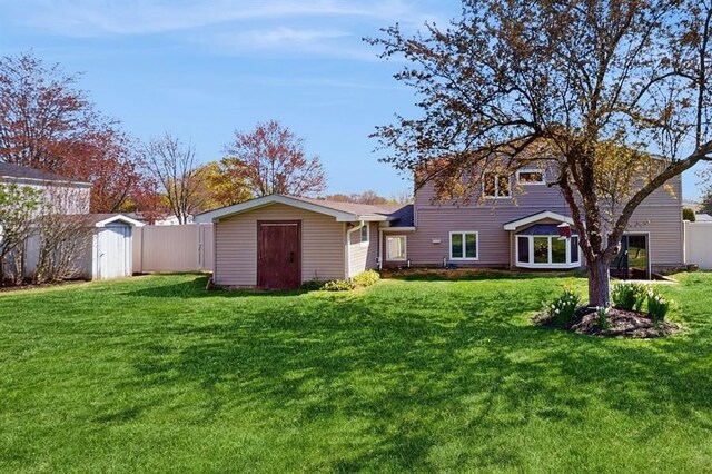 exterior space featuring an outdoor structure, fence, a yard, and a shed