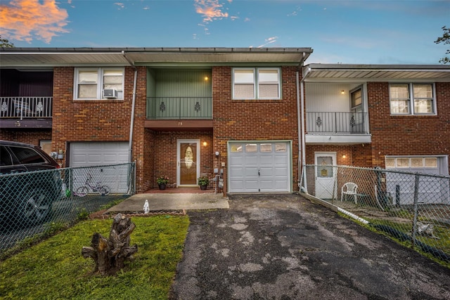 75 Vails Gate Heights Dr, Vails Gate, NY 12553 - townhome / multi-family property with driveway, an attached garage, cooling unit, brick siding, and a balcony