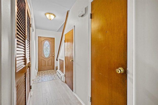 75 Vails Gate Heights Dr, Vails Gate, NY 12553 - entryway featuring a baseboard radiator, light wood-type flooring, and baseboards