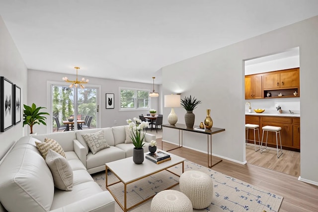 75 Vails Gate Heights Dr, Vails Gate, NY 12553 - living area with a chandelier, light wood finished floors, and baseboards