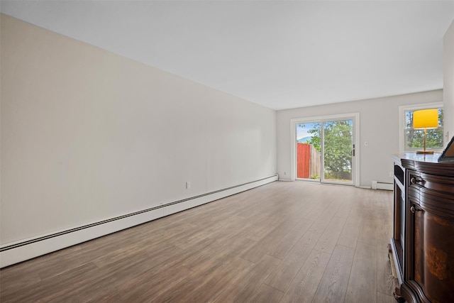 75 Vails Gate Heights Dr, Vails Gate, NY 12553 - unfurnished living room with a baseboard heating unit and wood finished floors