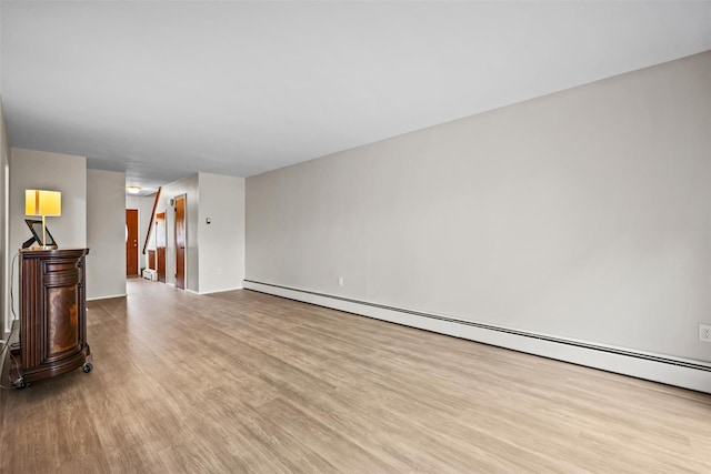 75 Vails Gate Heights Dr, Vails Gate, NY 12553 - unfurnished living room featuring wood finished floors and baseboard heating