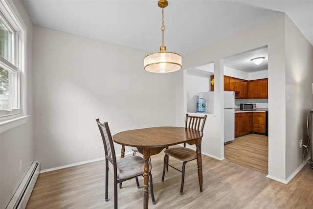 75 Vails Gate Heights Dr, Vails Gate, NY 12553 - dining room with a baseboard heating unit, light wood-style floors, and baseboards