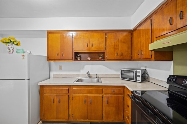 75 Vails Gate Heights Dr, Vails Gate, NY 12553 - kitchen featuring stainless steel microwave, freestanding refrigerator, black electric range oven, a sink, and light countertops