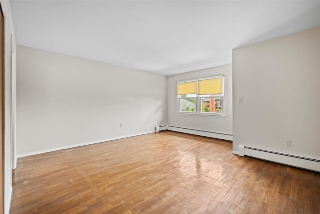75 Vails Gate Heights Dr, Vails Gate, NY 12553 - empty room with baseboard heating, wood finished floors, and baseboards