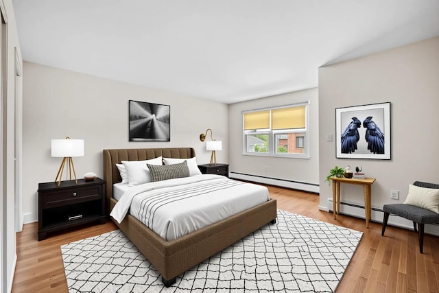 75 Vails Gate Heights Dr, Vails Gate, NY 12553 - bedroom with baseboard heating, light wood-type flooring, and baseboards
