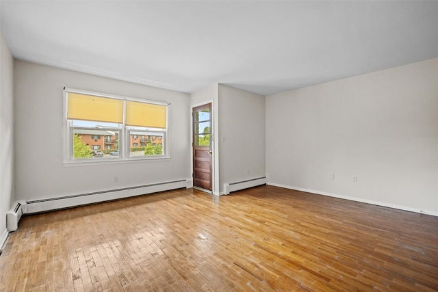 75 Vails Gate Heights Dr, Vails Gate, NY 12553 - empty room with baseboard heating, light wood finished floors, and baseboards