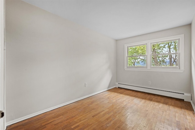 75 Vails Gate Heights Dr, Vails Gate, NY 12553 - spare room with a baseboard radiator, hardwood / wood-style floors, and baseboards