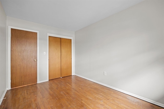 75 Vails Gate Heights Dr, Vails Gate, NY 12553 - unfurnished bedroom with baseboards, wood finished floors, and a closet