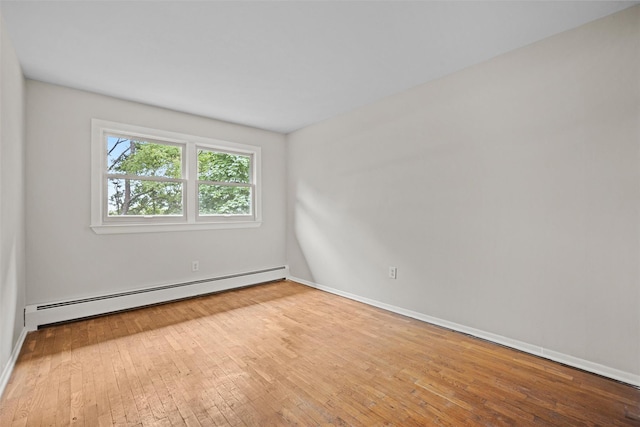 75 Vails Gate Heights Dr, Vails Gate, NY 12553 - empty room featuring a baseboard radiator, hardwood / wood-style floors, and baseboards