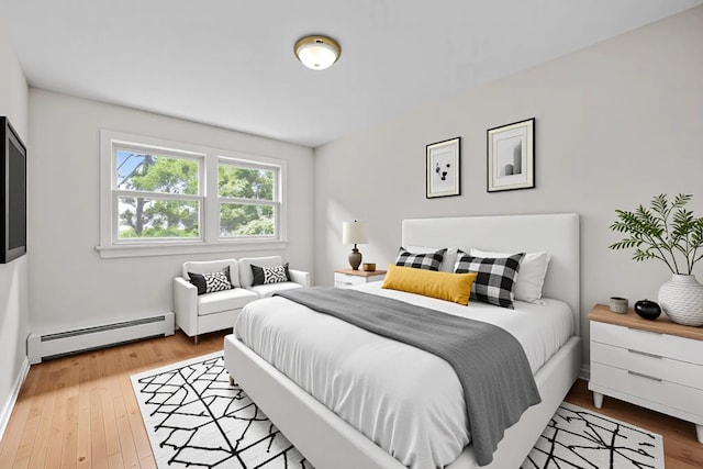 75 Vails Gate Heights Dr, Vails Gate, NY 12553 - bedroom featuring baseboard heating and wood finished floors