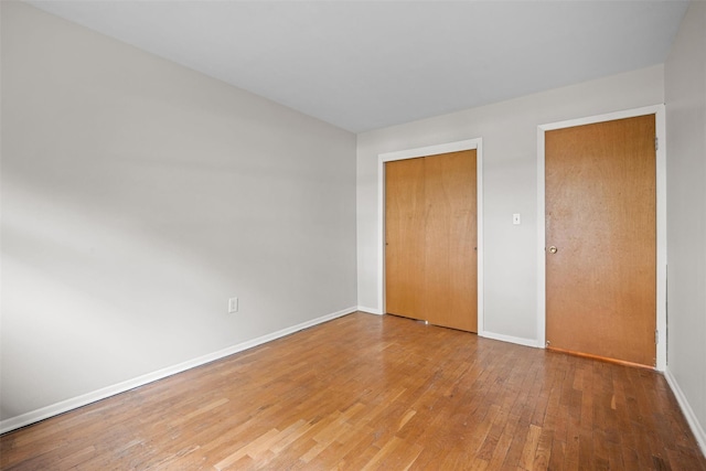 75 Vails Gate Heights Dr, Vails Gate, NY 12553 - unfurnished bedroom with light wood finished floors, baseboards, and a closet