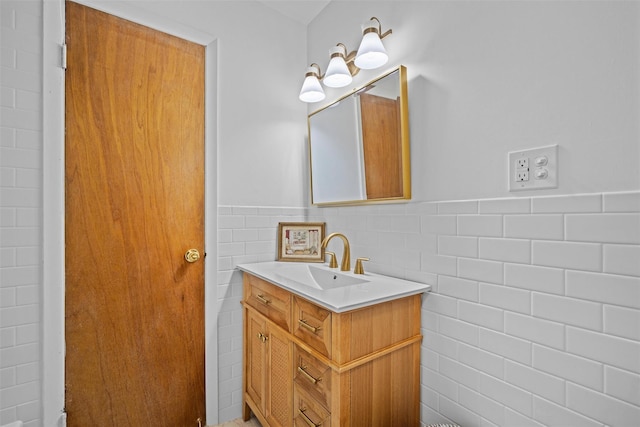 75 Vails Gate Heights Dr, Vails Gate, NY 12553 - bathroom featuring tile walls, vanity, and a wainscoted wall