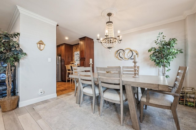 700 Shore Rd Unit 2Z, Long Beach, NY 11561 - dining space featuring baseboards, a chandelier, light wood-style floors, and crown molding