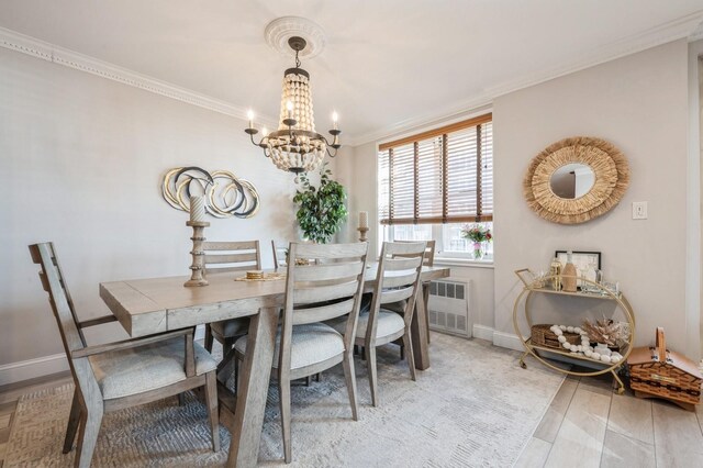 700 Shore Rd Unit 2Z, Long Beach, NY 11561 - dining space with radiator, crown molding, light wood-type flooring, an inviting chandelier, and baseboards