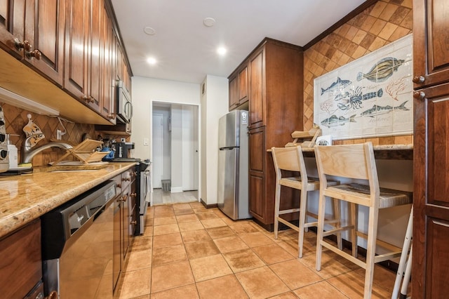 700 Shore Rd Unit 2Z, Long Beach, NY 11561 - kitchen with a sink, backsplash, light stone countertops, appliances with stainless steel finishes, and light tile patterned floors