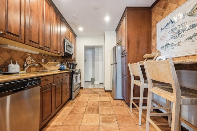 700 Shore Rd Unit 2Z, Long Beach, NY 11561 - kitchen with a sink, stainless steel appliances, backsplash, and light tile patterned floors
