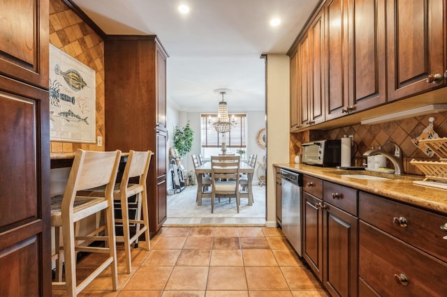 700 Shore Rd Unit 2Z, Long Beach, NY 11561 - kitchen featuring tasteful backsplash, an inviting chandelier, light tile patterned floors, a sink, and dishwasher
