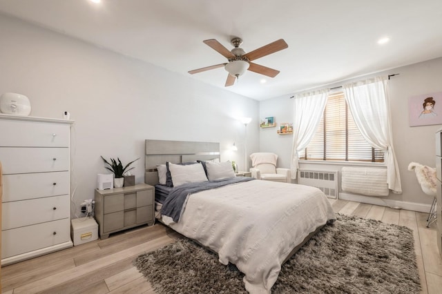 700 Shore Rd Unit 2Z, Long Beach, NY 11561 - bedroom with ceiling fan, radiator heating unit, recessed lighting, and light wood-type flooring